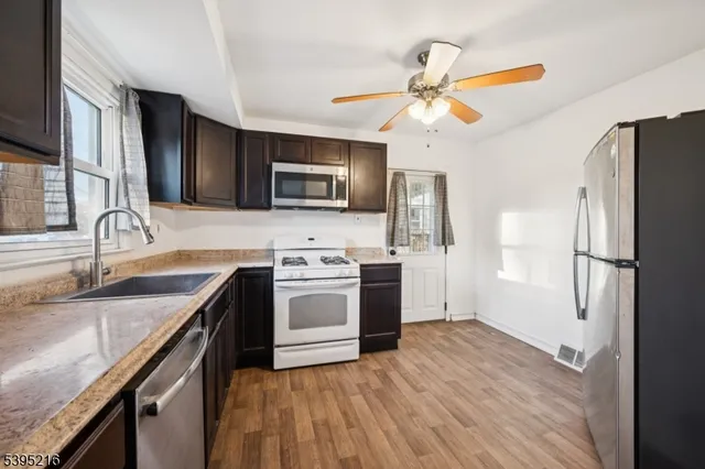 a kitchen with a sink stove and microwave