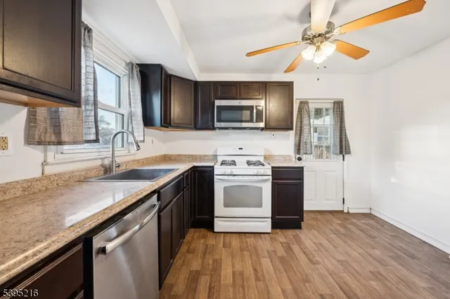 a kitchen with stainless steel appliances granite countertop a stove and a microwave