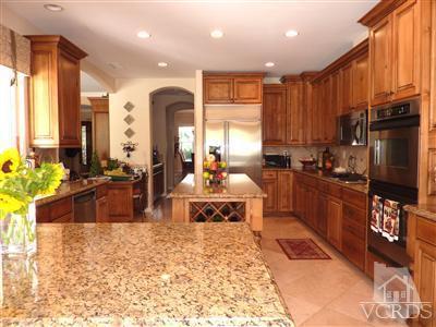 839 Rancho Road Thousand Oaks, CA 91362 - Photo 8 of 29 a large kitchen with kitchen island granite countertop a stove refrigerator and a sink