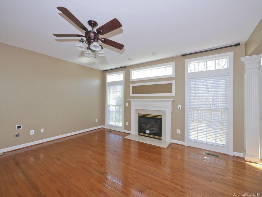 713 Reverdy Court Fort Mill, SC 29708 - Photo 5 of 19 an empty room with wooden floor a ceiling fan and windows