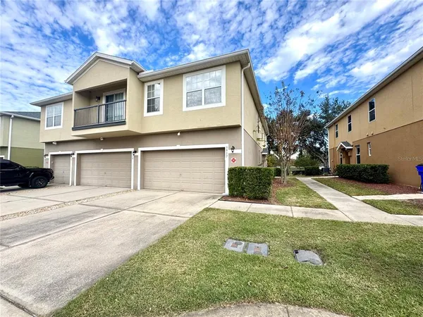 a view of a house with a yard and garage