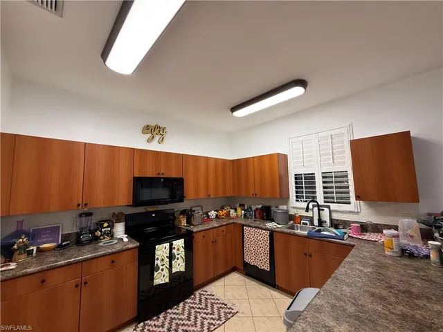 a kitchen with stainless steel appliances a stove sink microwave and refrigerator