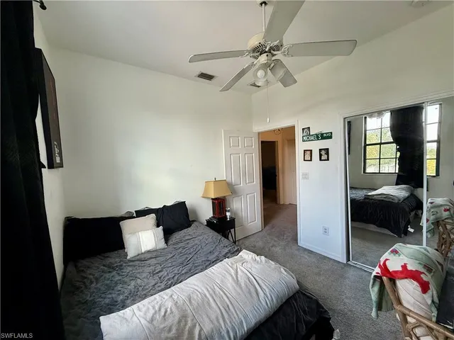 a bedroom with a bed and a couch