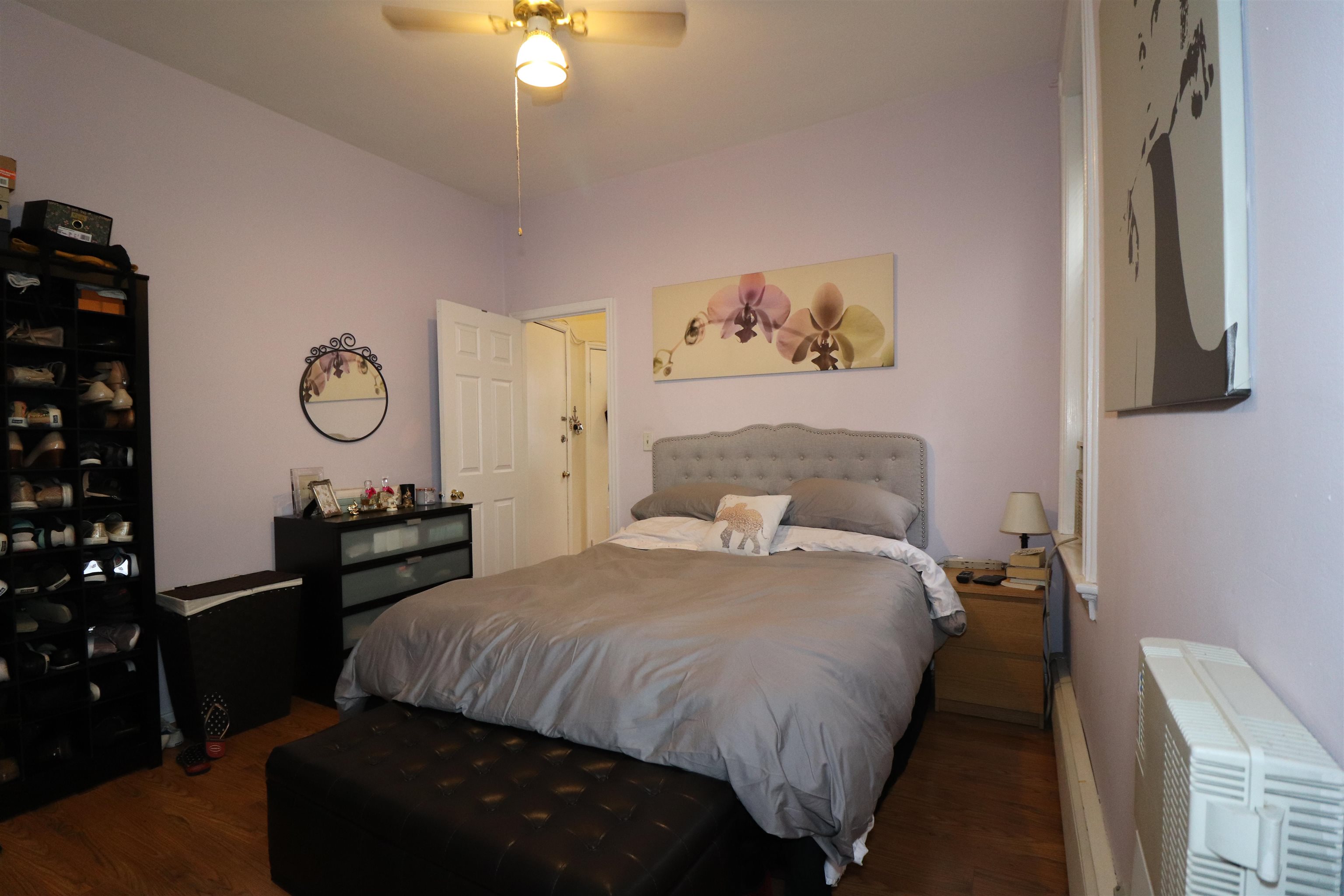 308 8th Street, Unit 2 Hoboken, NJ 07030 - Photo 7 of 8 a bedroom with a bed and a chandelier