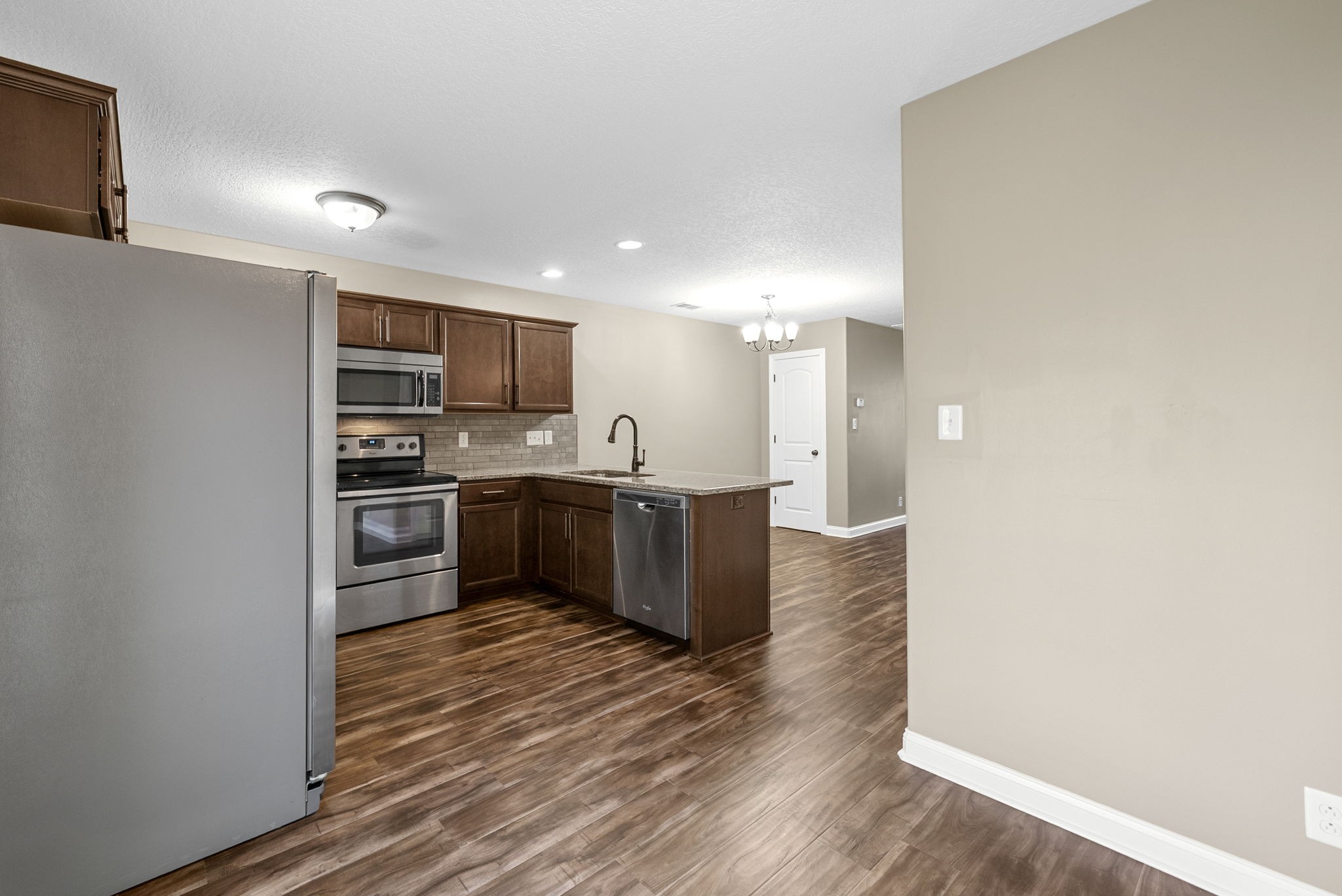 352 Sam Houston Circle Clarksville, TN 37040 - Photo 14 of 29 a kitchen with stainless steel appliances kitchen island granite countertop a stove and a refrigerator