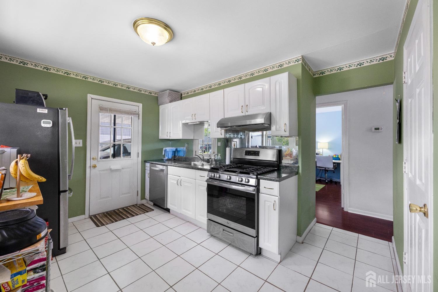 15 Winthrop Road Edison, NJ 08817 - Photo 8 of 26 a kitchen with stainless steel appliances granite countertop a refrigerator and a stove top oven