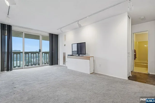 a view of a kitchen with a sink and a refrigerator