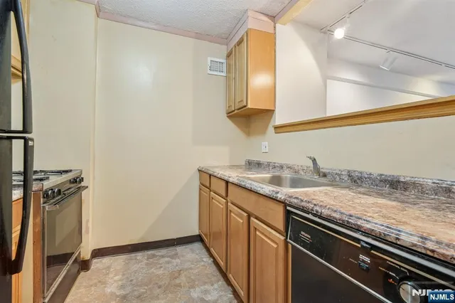 a kitchen with a stove and a sink