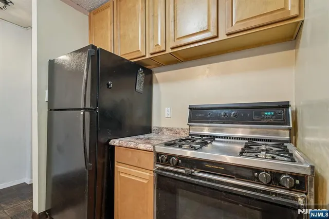 a stove top oven sitting inside of a kitchen