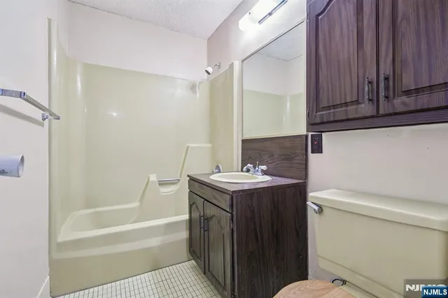 a bathroom with a sink a toilet and bathtub