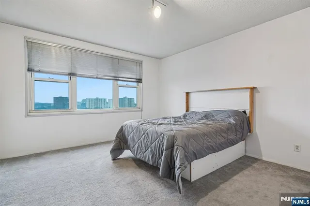 a bed sitting in a bedroom next to a window