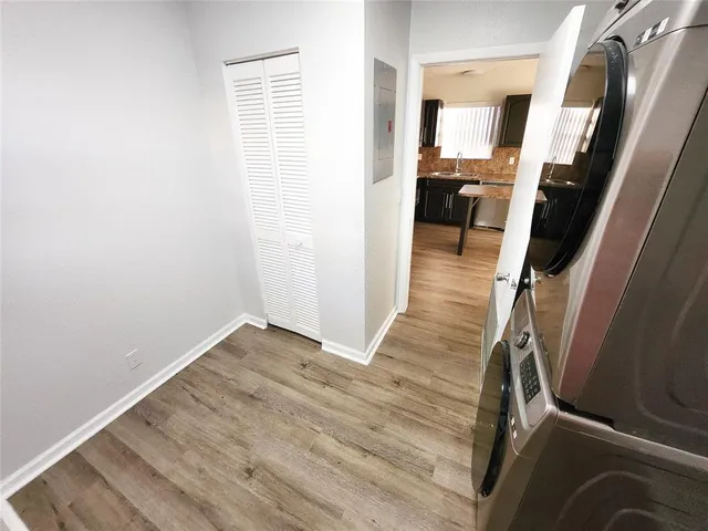 a view of a hallway with wooden floor