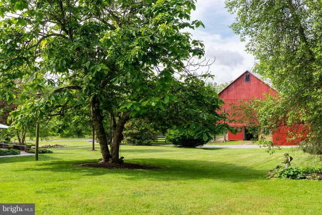 a view of a patio with furniture and a yard