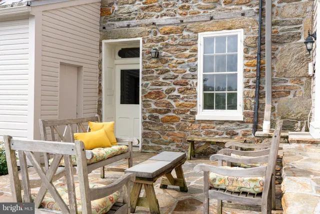 a view of a chairs and table in backyard of the house