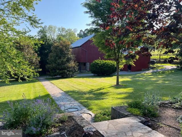 a view of a house with a yard and sitting area