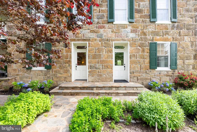 a living room with furniture a fireplace and a large window