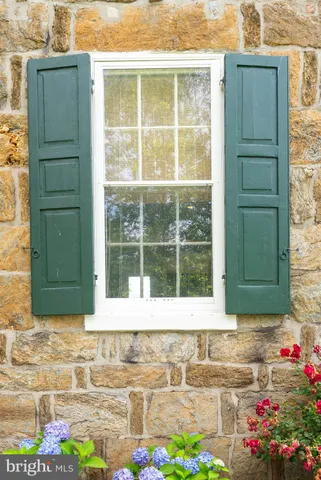 a kitchen with stainless steel appliances a stove top oven a refrigerator a dining table and chairs with wooden floor