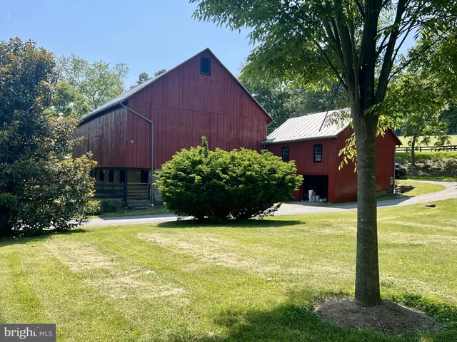 a front view of a house with swimming pool and glass windows