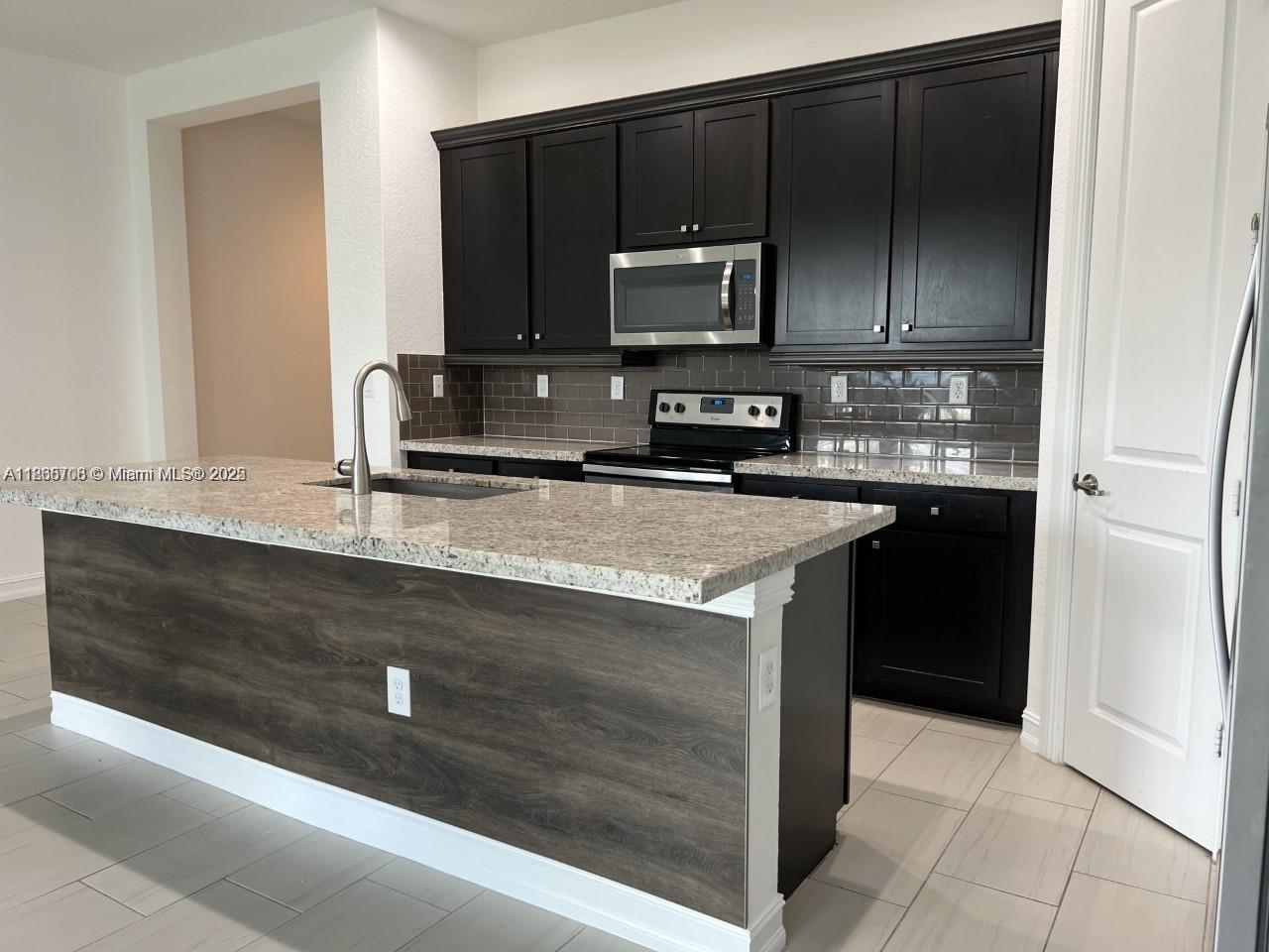 a kitchen with a sink and a microwave