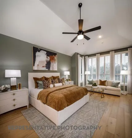 a bedroom with a large bed and a chandelier