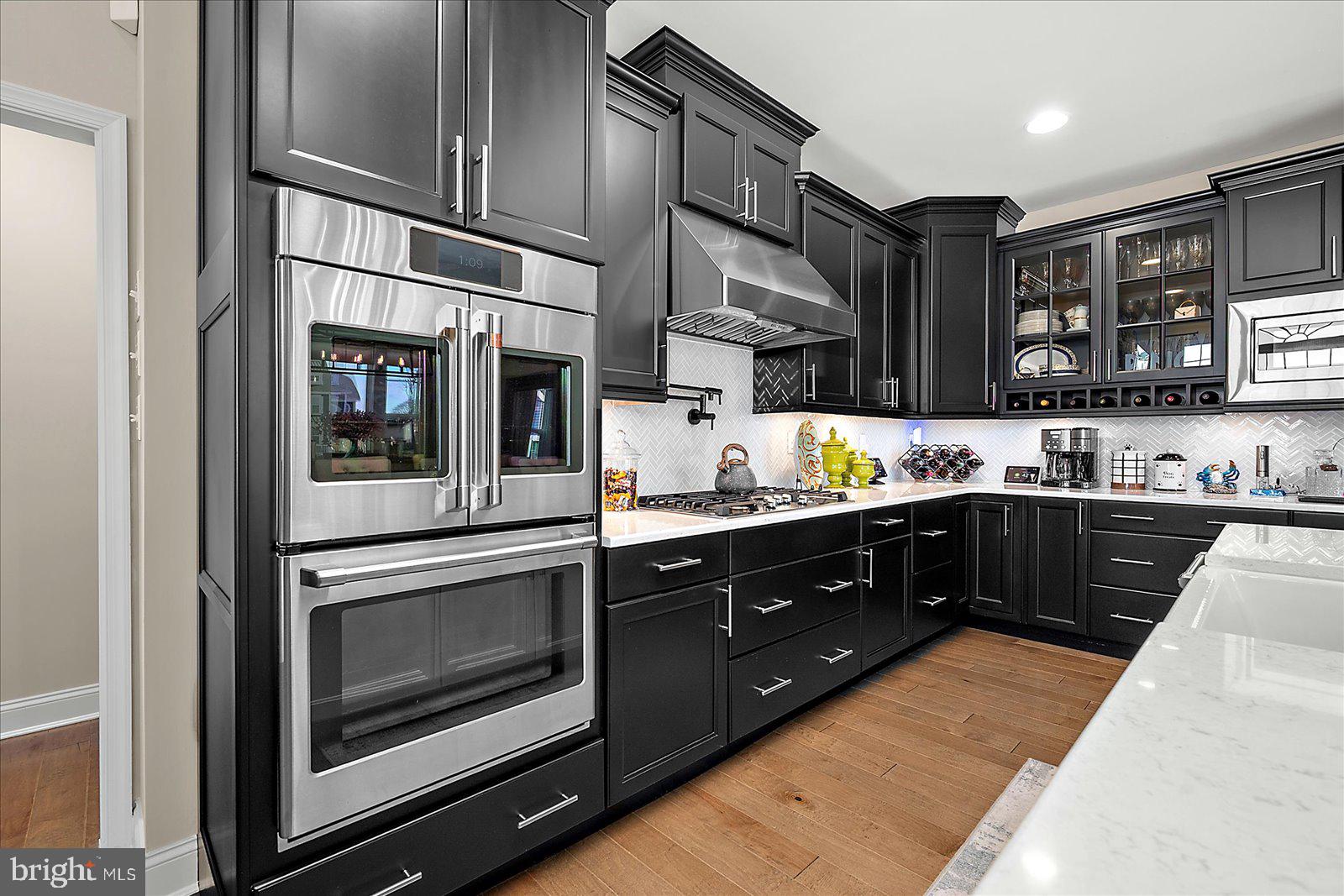 19218 American Holly Road Rehoboth Beach, DE 19971 - Photo 12 of 107 a kitchen with stainless steel appliances granite countertop a stove a sink and a microwave