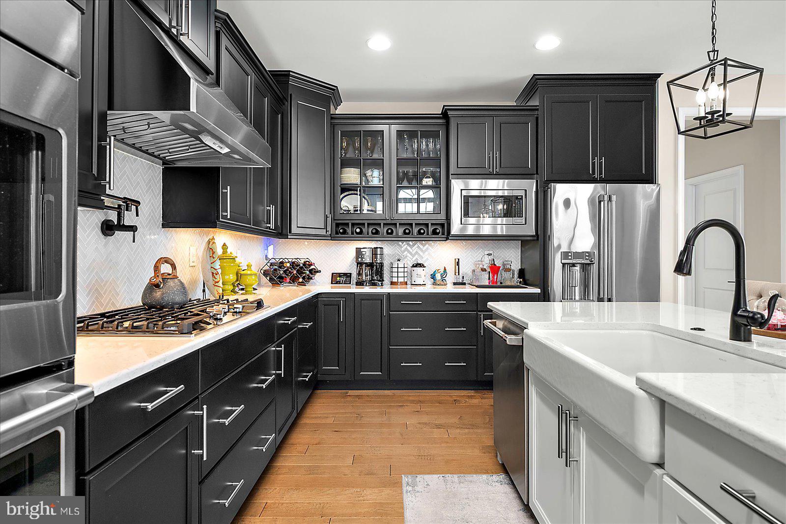19218 American Holly Road Rehoboth Beach, DE 19971 - Photo 15 of 107 a kitchen with stainless steel appliances granite countertop a sink stove and refrigerator