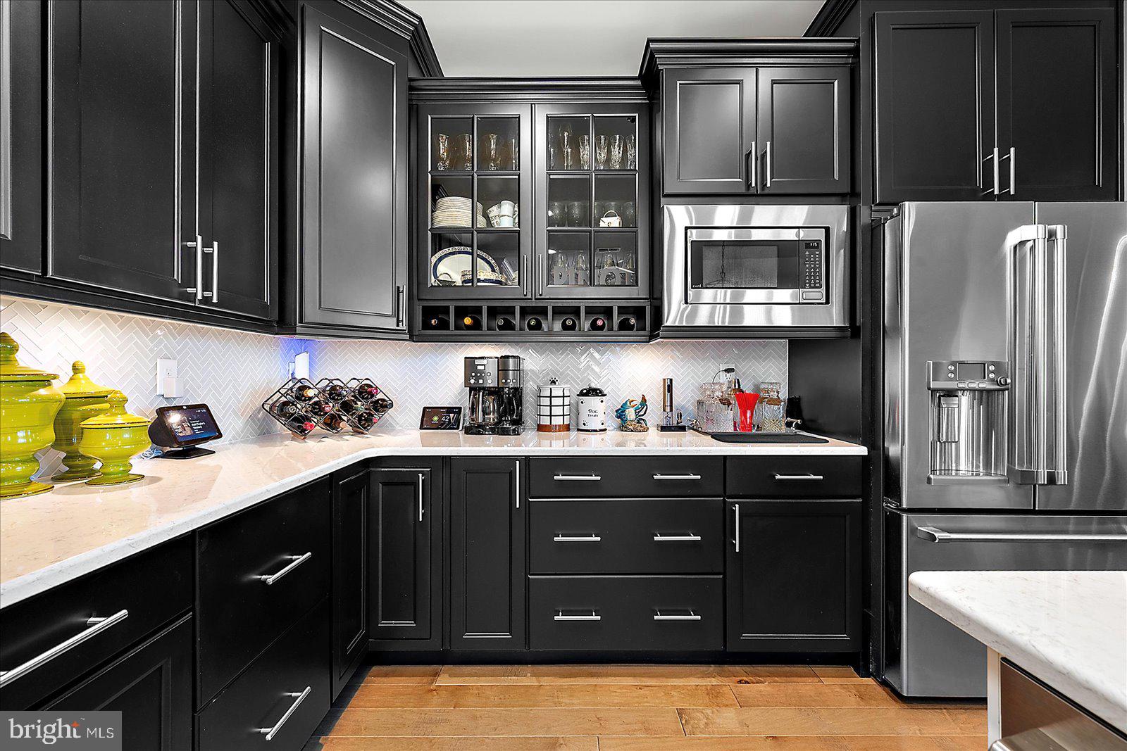 19218 American Holly Road Rehoboth Beach, DE 19971 - Photo 16 of 107 a kitchen with stainless steel appliances granite countertop a sink stove and refrigerator