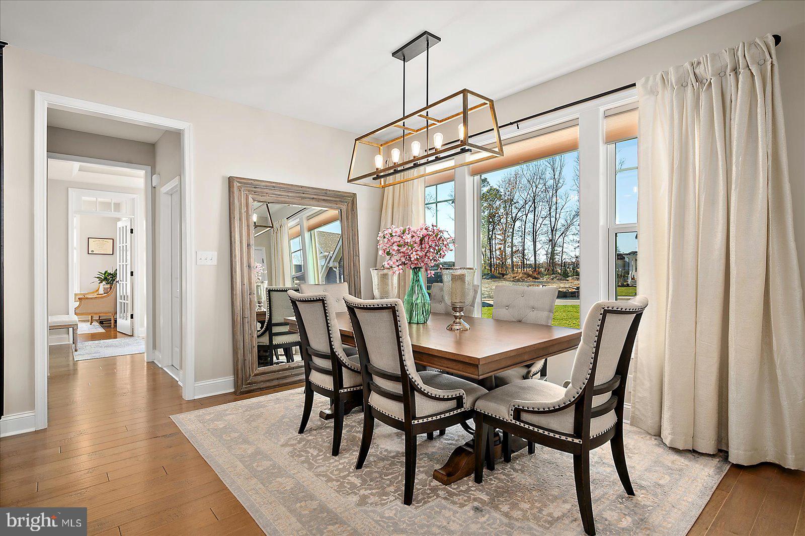 19218 American Holly Road Rehoboth Beach, DE 19971 - Photo 18 of 107 a view of a dining room with furniture window and wooden floor