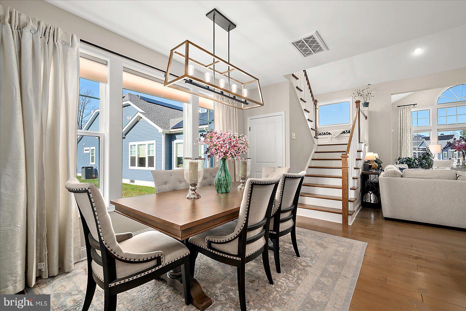 19218 American Holly Road Rehoboth Beach, DE 19971 - Photo 20 of 107 a view of a dining room with furniture and wooden floor