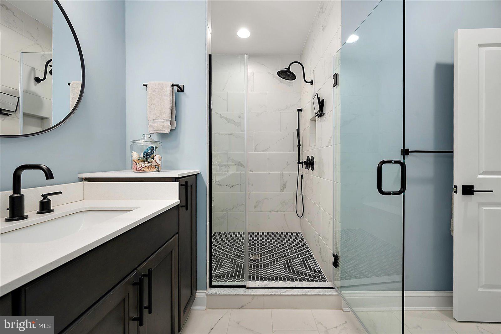 19218 American Holly Road Rehoboth Beach, DE 19971 - Photo 38 of 107 a bathroom with a double vanity sink mirror and shower
