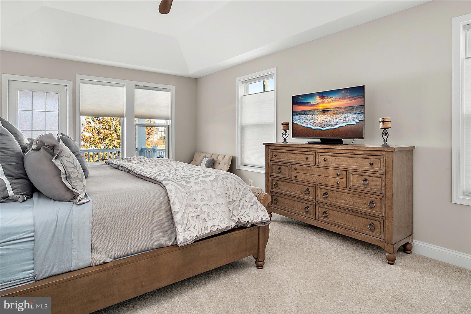 19218 American Holly Road Rehoboth Beach, DE 19971 - Photo 50 of 107 a bedroom with a bed and a flat screen tv