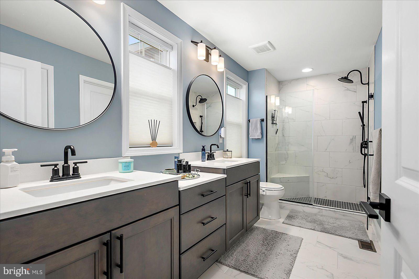 19218 American Holly Road Rehoboth Beach, DE 19971 - Photo 53 of 107 a bathroom with a double vanity sink mirror and shower