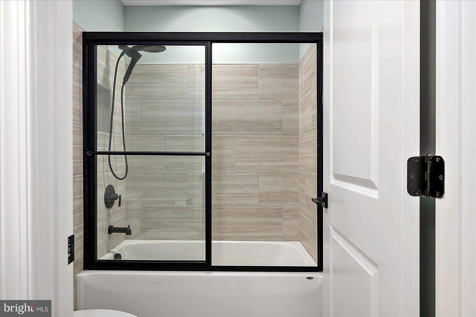 19218 American Holly Road Rehoboth Beach, DE 19971 - Photo 61 of 107 a bathroom with a glass shower door