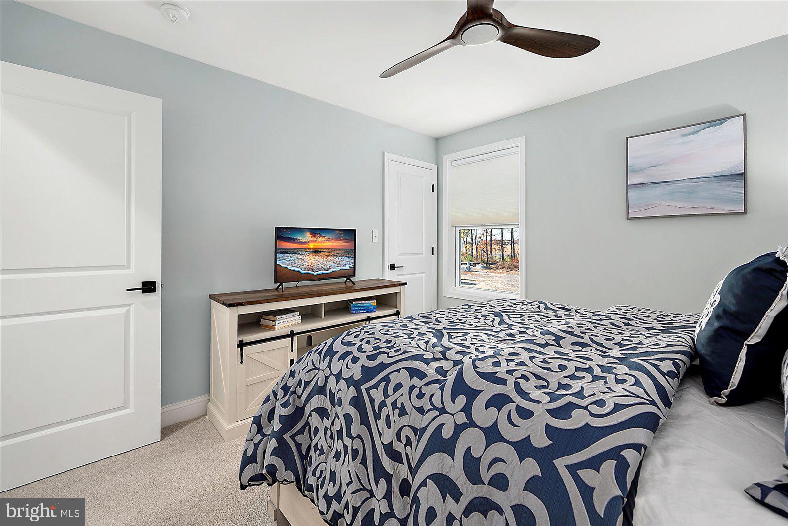 19218 American Holly Road Rehoboth Beach, DE 19971 - Photo 63 of 107 a bedroom with a bed and a window