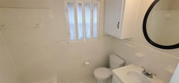 a white toilet sitting next to a bathroom sink