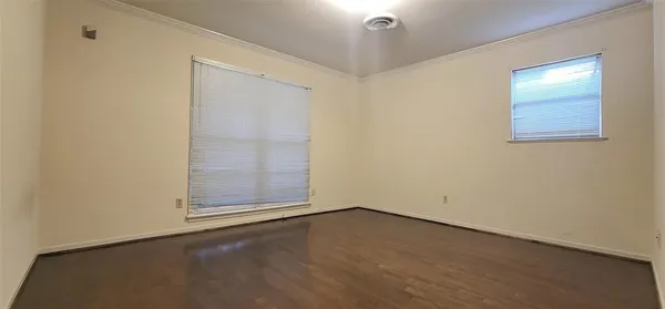 an empty room with a empty space and windows