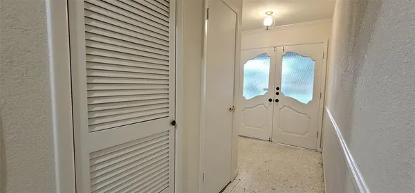 a bathroom with a glass shower door and a sink