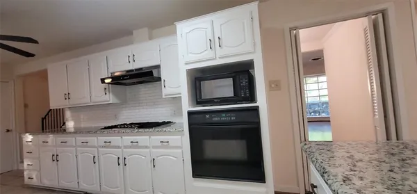 a kitchen with stainless steel appliances granite countertop a stove and a refrigerator
