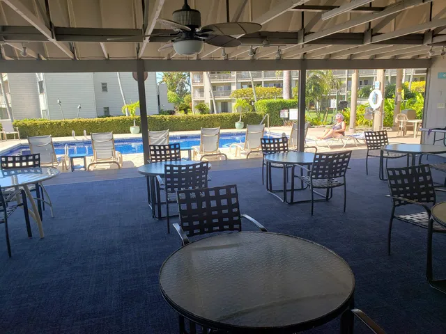 a outdoor space with lots of tables a garden and chairs