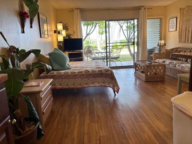 a spacious bedroom with a bed and glass windows