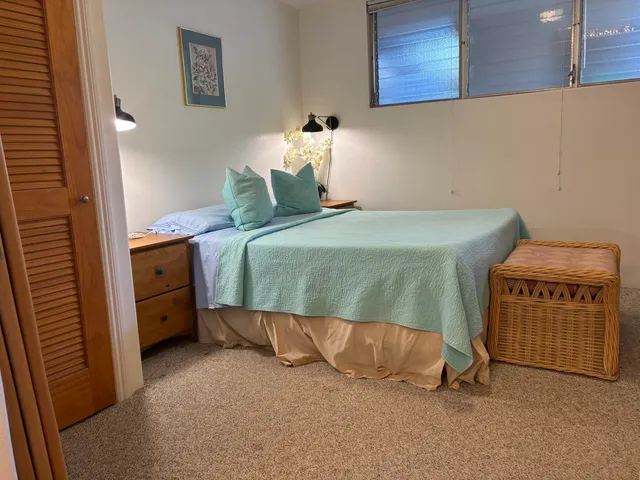 a bedroom with a bed and a cabinets