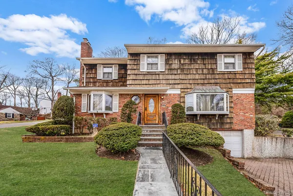 a front view of a house with a yard