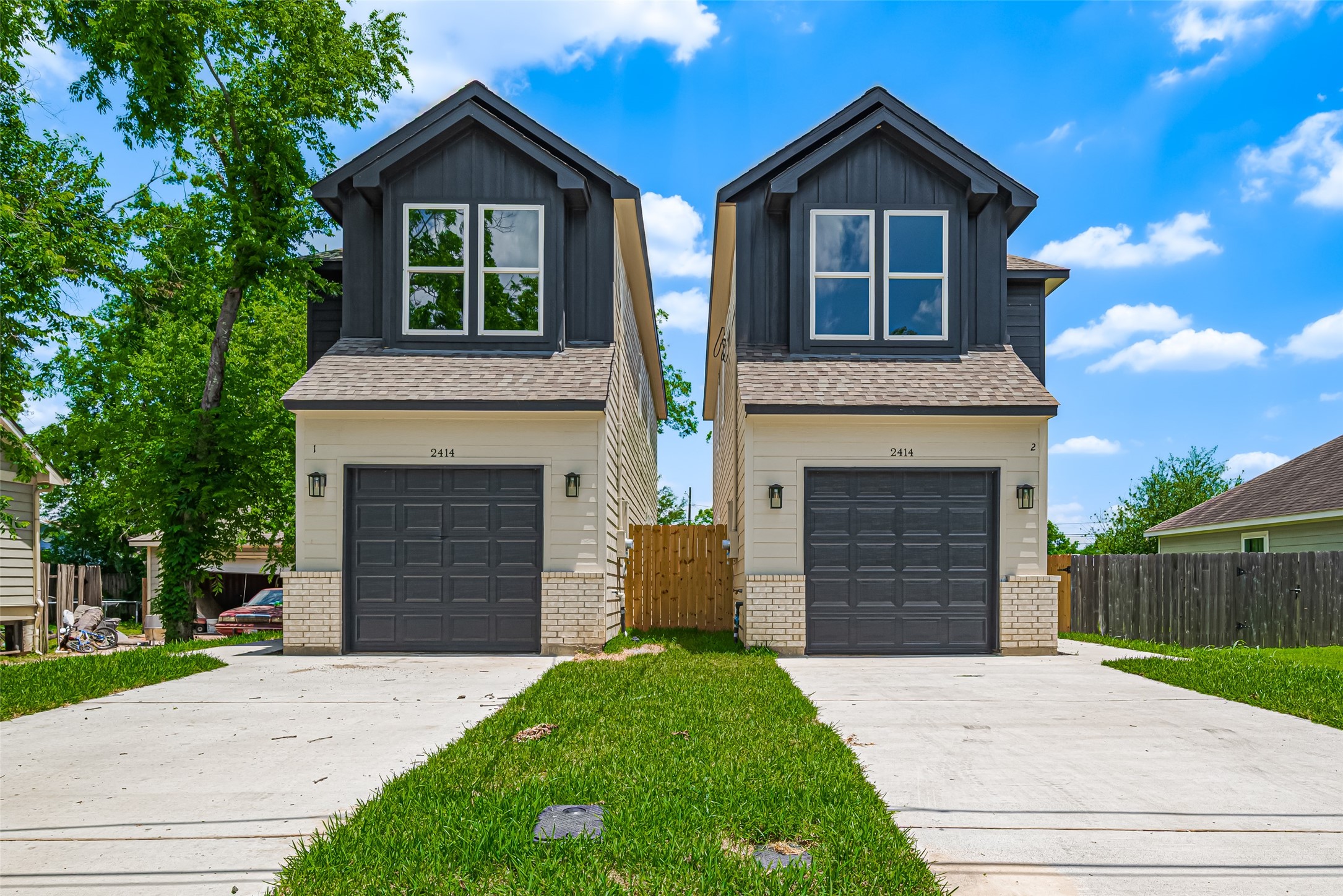 Perfect entryway surrounded by a neatly maintained lawn and fenced backyard.