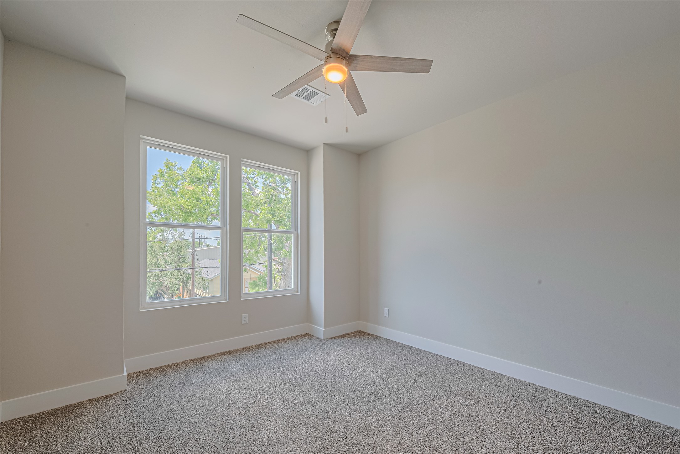 2414 Sam Wilson Street Houston, TX 77020 - Photo 23 of 29 an empty room with a window and a fan