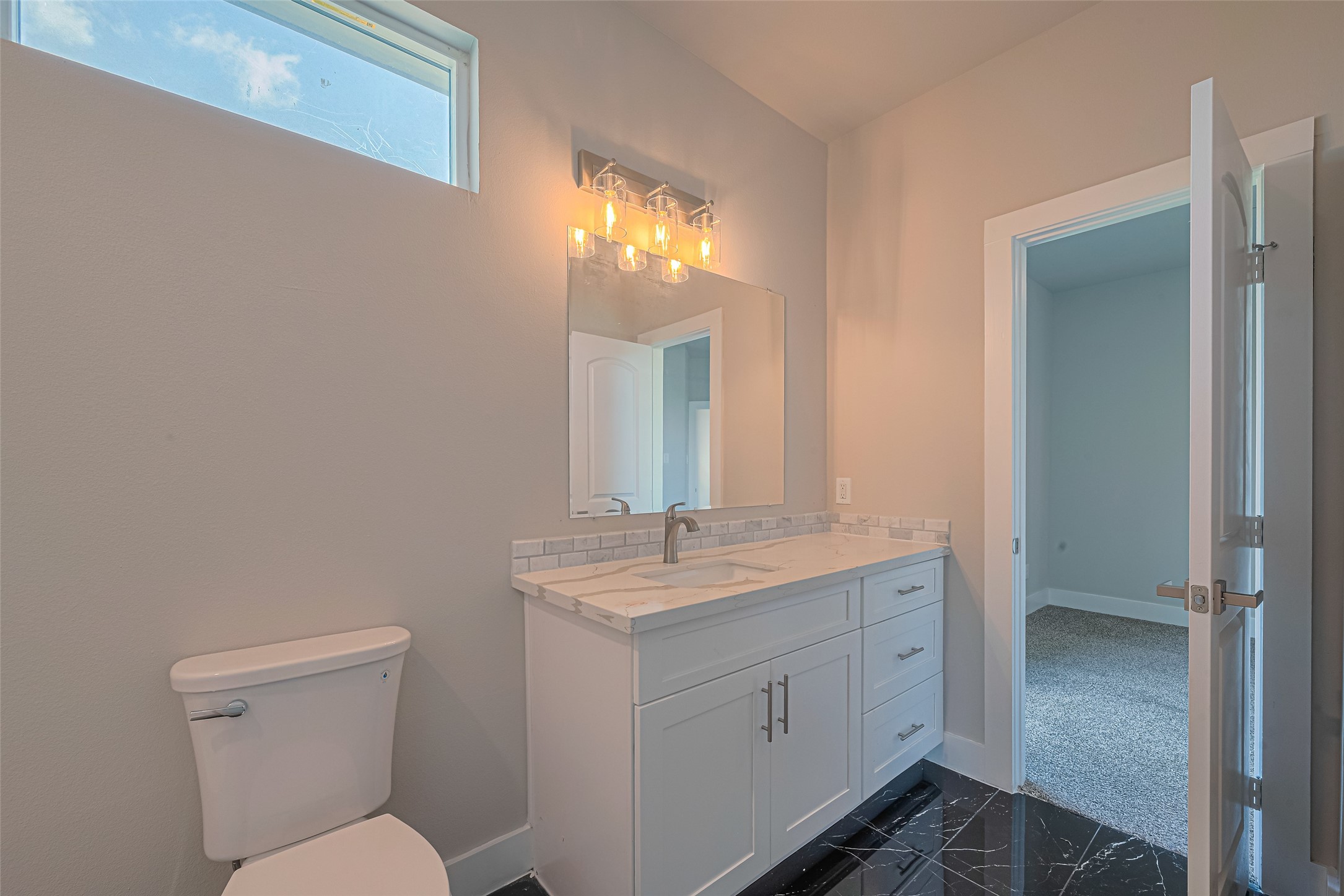 2414 Sam Wilson Street Houston, TX 77020 - Photo 25 of 29 a bathroom with a toilet sink and mirror