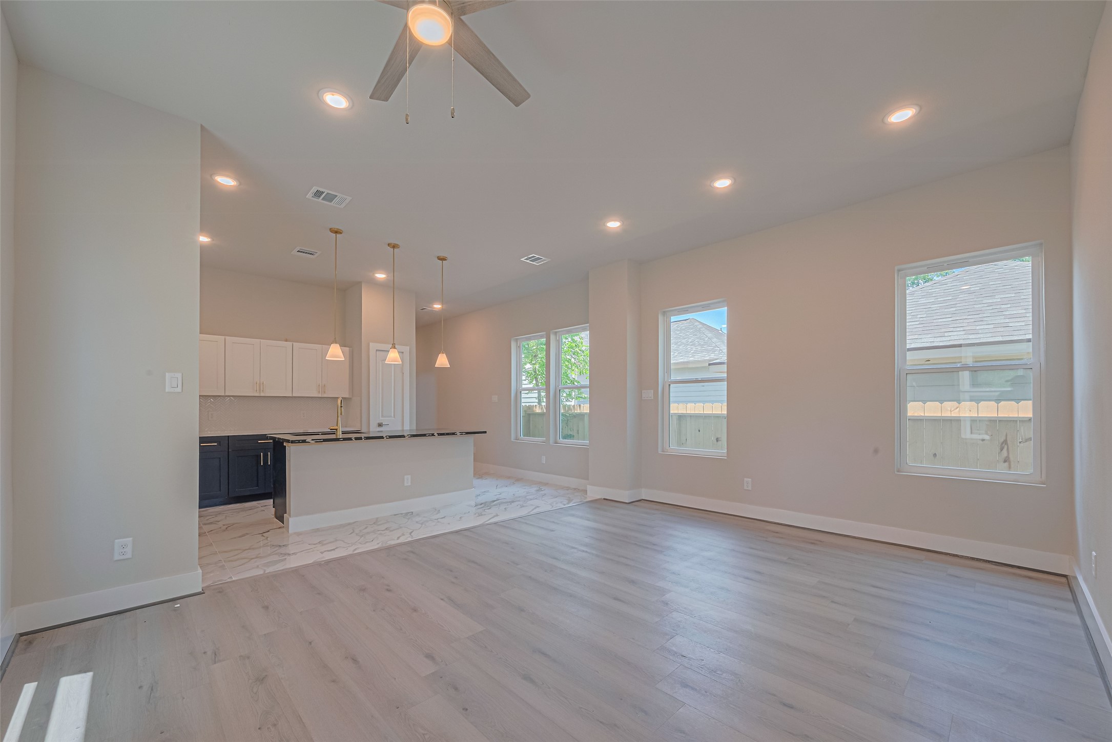 2414 Sam Wilson Street Houston, TX 77020 - Photo 6 of 29 an empty room with wooden floor and windows