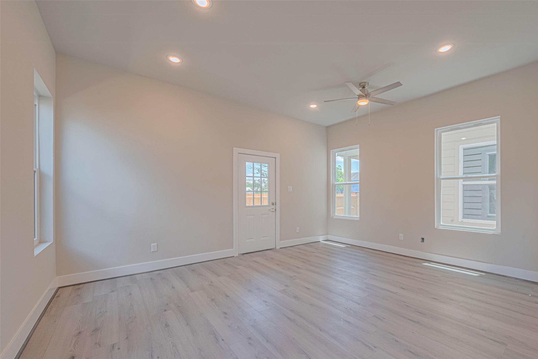 2414 Sam Wilson Street Houston, TX 77020 - Photo 7 of 29 an empty room with wooden floor and windows