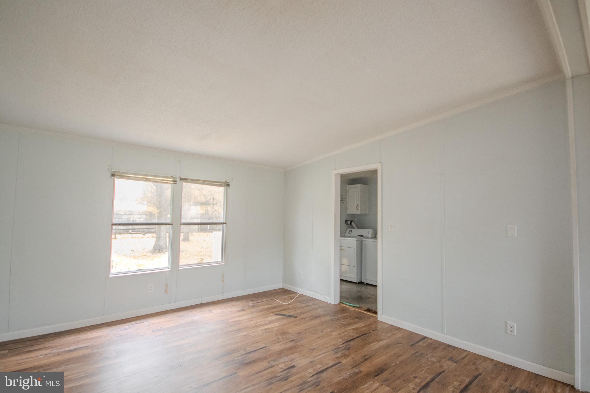 3887 Texas Road Bivalve, MD 21814 - Photo 13 of 34 an empty room with wooden floor and windows