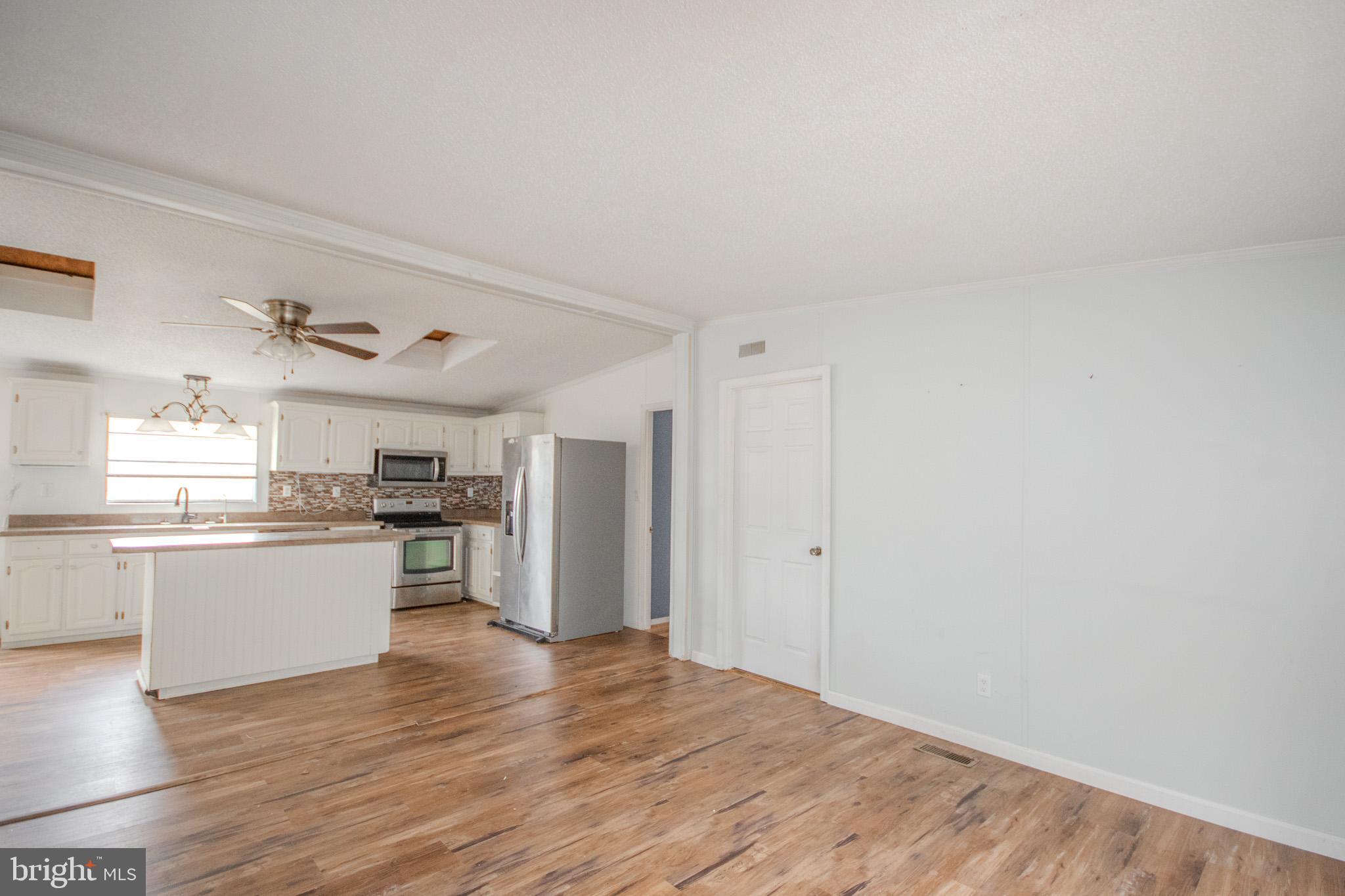 3887 Texas Road Bivalve, MD 21814 - Photo 14 of 34 a kitchen with a refrigerator and a stove top oven