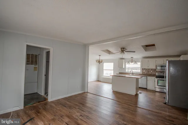 a kitchen with stainless steel appliances a refrigerator sink and stove